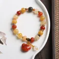 Macro detail of natural silk jade beads and ruyi pendant on a white ceramic plate - Barrel Bead Peace Lock Pendant