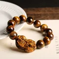 Natural yellow tiger eye stone bracelet featuring a carved PiXiu charm with cat-eye effect - 14mm Bead And Pixiu