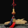Traditional boxwood carving of a young monk with a red and blue tassel keychain - A1 Lotus Seated Little Monk