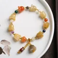 Detailed close-up of lily of the valley beaded bracelet with colorful gemstones and pearls - Lily of the Valley Jade Bracelet