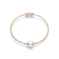 Detail of 14K gold-filled cuff bracelet with a large baroque pearl and two side pearls - Purple