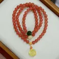Macro shot of cherry red agate bead bracelet with a yellow amber rose flower pendant - Triple Wrap / Cherry Red Style (A2)
