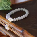 Natural jade beaded bracelet with shell flower charm and gold droplet details - Light Green Round Beads Shell Flower Jade Pearl Waterdrop Style