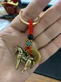 Detail of brass horse pendant with coin and woven red rope for a lucky keychain charm - Horse And Red Rope Five Emperors Coin
