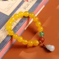 Beaded natural yellow agate bracelet with white jade gourd charm and gold metal accents - Yellow Agate Gold Plated Jadeite Gourd