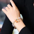 Macro detail of natural pumpkin-shaped gemstone beads on a colorful beaded bracelet - Multi-color Pumpkin Jade Bracelet