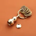 Brass gourd keychain with hollow structure and five emperor coins on a warm background - Brass Hollow Large Gourd Five Emperor Coins