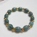 Close-up of natural green jade beads with gold threaded spacers in a beaded bracelet - Large Rice Beads