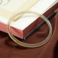 Translucent slim chalcedony bangle in pale yellow on a traditional Chinese background - Plain Greyish Brown