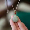 Natural Nephrite Jade Buddha necklace pendant with hand-woven brown cord and red bead - Hetian Jade Hug Buddha Necklace