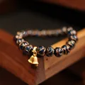 Blue glass bead bracelet with gold glitter patterns and decorative twin bells - Blue Glaze Bracelet Double Bell Style