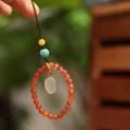 Orange carnelian bead phone charm with white jade lotus pendant and green bead accents - Red Agate Chalcedony Rabbit Style