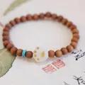 Handcrafted Bodhi seed bracelet with brown wood beads and a white cat paw charm - Sandalwood / Barbi Sandalwood Cat Paw Bracelet