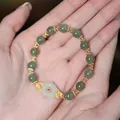 Natural Hetian jade beaded bracelet featuring green round beads and a white carved lotus flower - Hetian Jade Round Bead Plum Blossom Spacer Bracelet