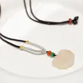 Close-up of Ruyi cloud-shaped jade pendant with a woven cord and colorful beads - Dark Coffee Chalcedony Ruyi Lock Necklace