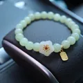 Natural Hetian jade bead bracelet with white flower charm and golden Fu tag - White Jade Plum Blossom Bless Tag Style