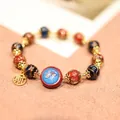 Ethnic beaded bracelet with red and blue glazed beads and golden auspicious charms - Red And Blue Glaze Bracelet