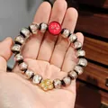 Ethnic beaded bracelet with marble textures, red charm, and golden clover detail - White Glaze