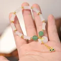 Bamboo-style jade bracelet with white money bag charm and gold fortune coin tassel - 6*12MM Glaze Fine Bamboo Money Bag Style