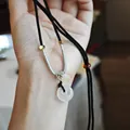 White chalcedony donut pendant on black cord necklace with minimalist metal accents - Black Chalcedony Peace Buckle Lock Necklace