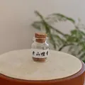 Laoshan Sandalwood incense beads in a clear glass bottle with a cork stopper - Sandalwood Incense Pills (Bottled)