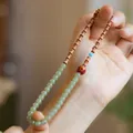 Double-wrap sandalwood and jade bracelet with translucent green beads and wooden accents - Lacquer Nephrite Jade Style