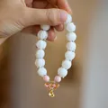 Handmade beaded lily of the valley bracelet with pink beads and a gold butterfly charm - Porcelain White Glazed Glass Lotus Butterfly Style
