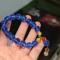 Handmade beaded bracelet with translucent blue pumpkin glass beads and gold accents - Deep Blue Glazed Glass Lotus Bracelet