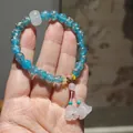 Handmade beaded bracelet with gold-foil blue glass beads and pink flower charms - Sunny Mountain Blue Glazed Glass Lily of the Valley Bracelet