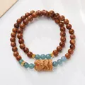Brown Kuk beads bracelet with blue jadeite stones and hand-carved monk pendant - Blue Water Kuka Zhajilamu Style