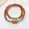 Double-wrap wooden bead bracelet with blue gemstone and carved Buddha pendant - Blue Water Jade Sandalwood Style
