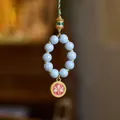 Ethnic blue ceramic phone strap with golden cylinder and lucky charm pendant - Gray Incense Ash Porcelain - Red Wealth God