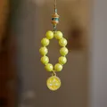 Ethnic yellow bead phone charm with golden prayer wheel and protective eye pendant - Gold Incense Ash Porcelain - Yellow Wealth God
