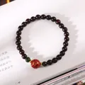 Sandalwood beaded bracelet with red lacquer dragon bead on a vintage book page - Red Lacquer Bead Single Loop Sandalwood
