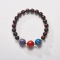 Detailed view of red sandalwood beads with colorful lacquer texture and golden spacers - Three Lacquer Beads Nine Purple Fire Sandalwood