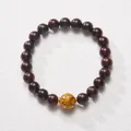 Macro shot of sandalwood beads bracelet with yellow lacquer bead and golden spacers - Yellow Lacquer Bead Sandalwood