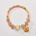 Detail of pink enamel metal tube and translucent sunstone beads on a lotus floral bracelet - Pink Rich Flower Style