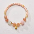 Pink sunstone bracelet featuring enamel butterfly bangle and delicate lily of the valley bell - Pink Lily of the Valley Lucky Rooster Edition