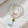 Dettaglio macro del bracciale multistrato in giada verde con ciondolo a motivo floreale - Giada Tianshan Ghirlanda di Fiori Nappina 3