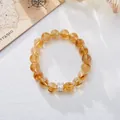 Macro detail of yellow citrine bead bracelet with square zircon charm on textured background - 10mm Yellow Azozeo White Square Zirconia