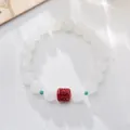 Minimalist white jade bead bracelet with red cinnabar bead and green spacer accents - Large Bead Style