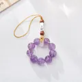 Detailed macro view of amethyst beaded phone charm with engraved metal lucky character - Purple Amethyst Auspicious Style
