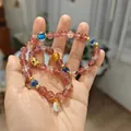 Pink strawberry crystal beaded bracelet with gold PiXiu charm and colorful gemstone accents - Multi-Layer Auspicious Design Style