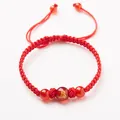 Red braided rope bracelet featuring a red agate bead with a golden monkey zodiac pattern - Zodiac Monkey