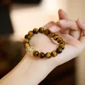 Natural tiger eye stone beaded bracelet with yellow crystal accent on hand - Liunian Mijing (Tiger Eye + Citrine)