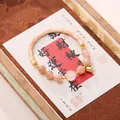 Buddhist beaded bracelet with pink sunstone beads and golden bell charm for women - Sunstone Lily of the Valley Bracelet
