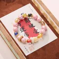 Pink beaded bracelet with floral carving, gold charms, and lucky stone beads for women - Pink Glass Phoenix Style Bracelet