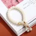 Handcrafted white Bodhi seed bracelet with lucky cat and cat paw charms for meditation - Charred Cat Paw Kitten Tassel Style