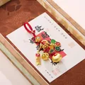 Chinese Buddhist bracelet with golden bells, red braided cord, and lucky charms - Fortune Bag Peace and Joy Keychain