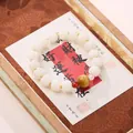 Traditional Chinese beaded bracelet with white melon beads and golden accents in a gift box - Pumpkin Bodhi and Tiger Eye Bracelet
